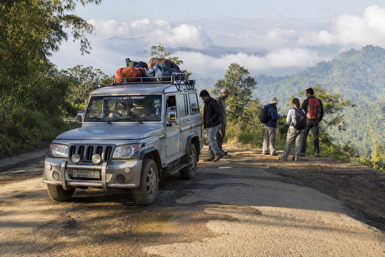 A jeep, secured trekking packs and travellers with a local guide at the start of a Bandarban ridge journey