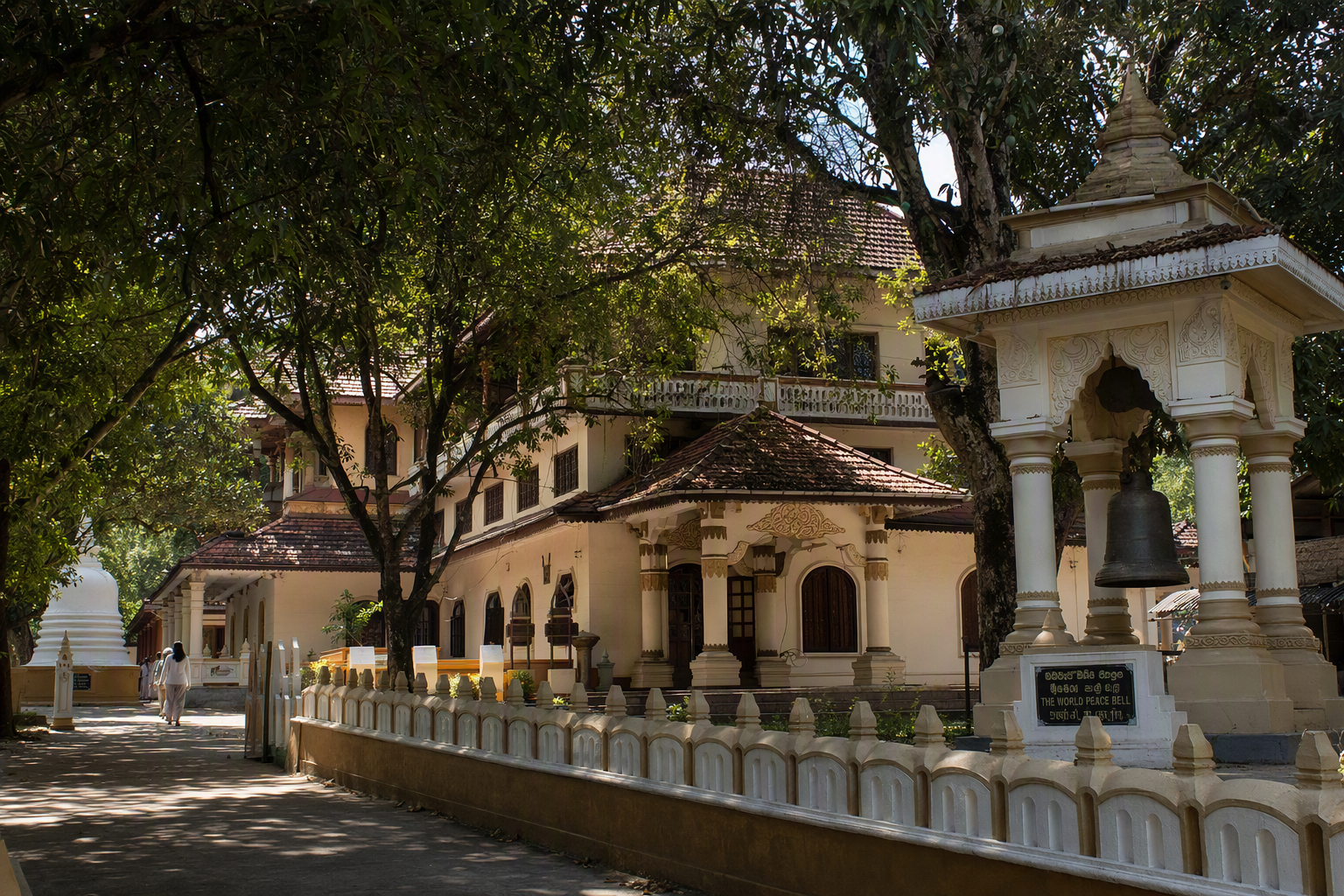Rajban Vihara framed by mature trees in soft morning light
